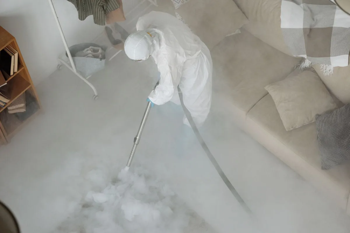 Biohazard cleanup technician in protective equipment, St. Cloud, MN